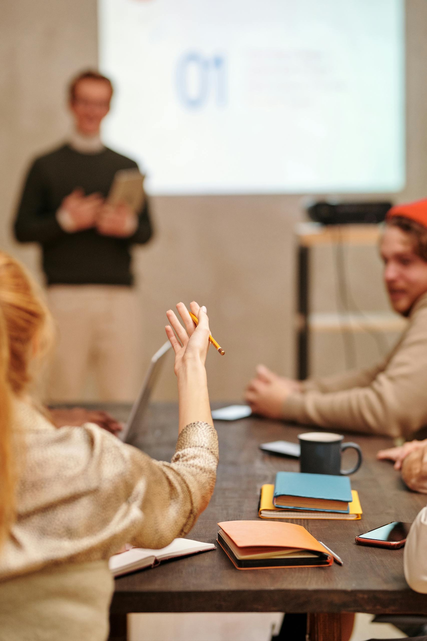 Diverse team engaged in a meeting with a presentation in a modern office setting.